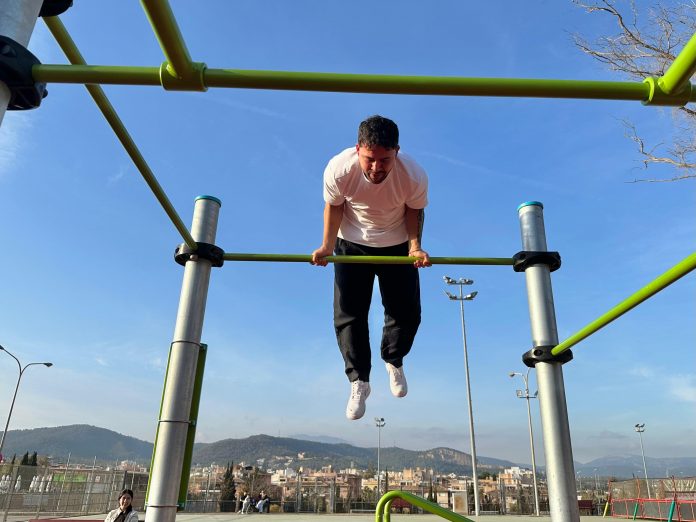 El IME amplía el parque de calistenia de Son Moix e incorpora módulos adaptados para personas con movilidad reducida La actuación, con una inversión superior a los 17.000 euros, refuerza el compromiso del Ajuntament de Palma con el deporte inclusivo y la mejora de las instalaciones municipales. Palma, 30 de diciembre de 2025. El Institut Municipal de l’Esport (IME) ha llevado a cabo la ampliación del parque de calistenia del Palau Municipal d’Esports de Son Moix, una intervención que responde al incremento de usuarios de esta instalación y que introduce, por primera vez, módulos específicos para personas con movilidad reducida, avanzando hacia un modelo deportivo más accesible e inclusivo. La mejora ha incluido la instalación de dos nuevos módulos adaptados, así como la colocación de 105 metros cuadrados de pavimento continuo de cuatro centímetros de grosor. Además, se ha incorporado un nuevo conjunto de equipamientos destinados a la práctica de Street Workout, una disciplina basada en ejercicios de fuerza con el propio peso corporal y muy arraigada en espacios públicos y al aire libre. El nuevo equipamiento está formado por diez postes y barras paralelas inclinadas, configurando un espacio completo que permite la práctica deportiva a distintos niveles. Todos los elementos cumplen con la normativa europea vigente para equipamientos de entrenamiento al aire libre, garantizando seguridad, calidad y durabilidad para los usuarios. La actuación ha sido adjudicada a la empresa Agapito Urban Industrias SL por un importe total de 17.427,03 euros, IVA incluido. Con esta intervención, el Ajuntament de Palma refuerza su apuesta por el deporte al aire libre, la accesibilidad universal y la mejora continua de los espacios deportivos municipales. Además, el IME ha completado otra actuación relevante en el polideportivo Toni Servera, donde se ha instalado una nueva lona homologada para la práctica de la gimnasia rítmica. Esta mejora permitirá garantizar la calidad y la seguridad de los entrenamientos y abre la puerta a la organización de competiciones federadas en esta instalación. La inversión destinada a la adquisición de la lona ha sido de 7.441,50 euros. Con estas actuaciones, el IME continúa avanzando en la modernización de las infraestructuras deportivas de la ciudad, adaptándolas a las necesidades actuales y promoviendo un deporte más inclusivo y de calidad para toda la ciudadanía.